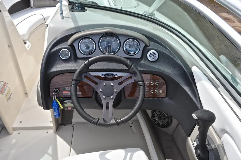 Slide: The Image of 2005 Sea Ray 220 Select boat dashboard with steering wheel and instrument panel. - 24
