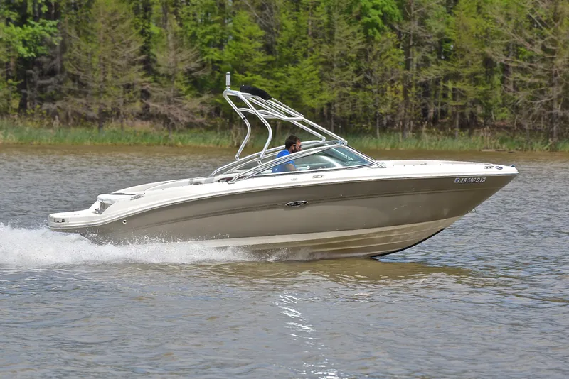 Slide: The Image of 2005 Sea Ray 220 Select boat cruising on a lake with forested background. - 3
