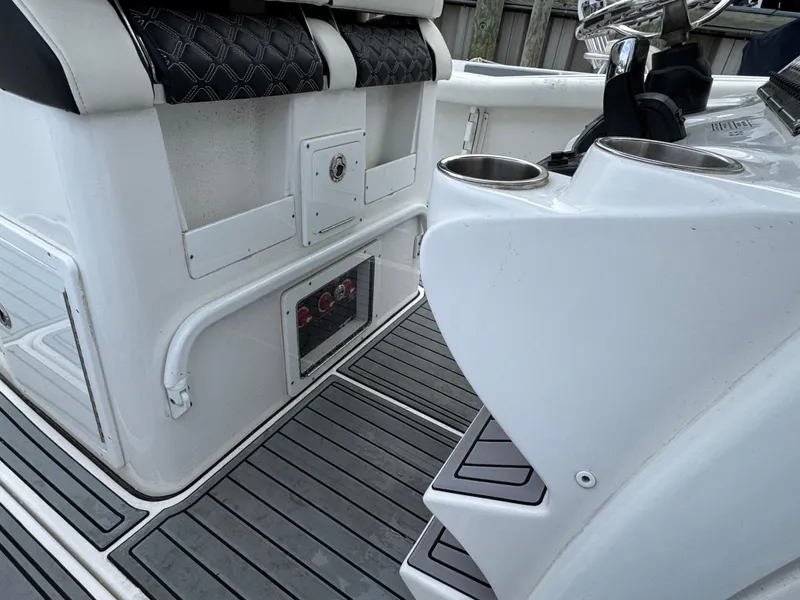 Slide: The Image of 2022 Tidewater 292 CC Adventure boat interior with seating and cup holders. - 11