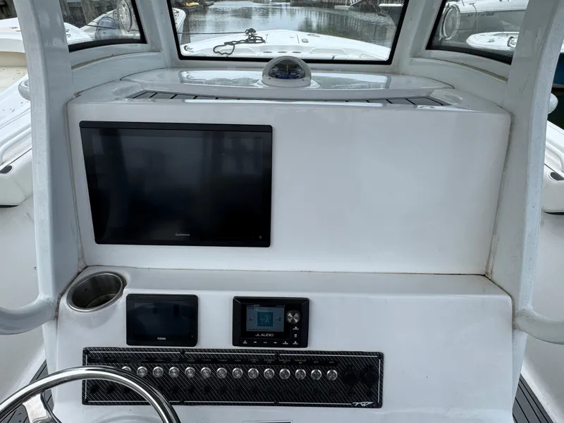 Slide: The Image of 2022 Tidewater 292 CC Adventure boat dashboard with navigation screens and controls. - 12