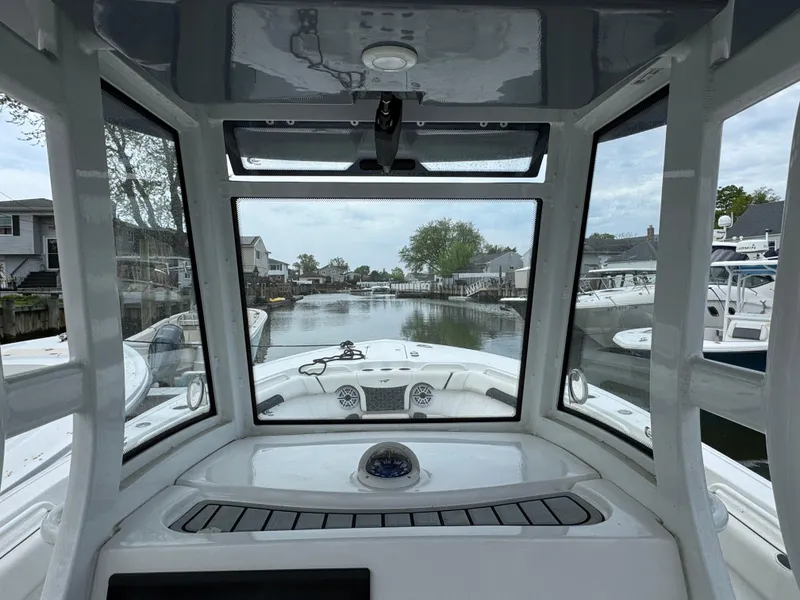 Slide: The Image of Interior view from a 2022 Tidewater 292 CC Adventure boat, overlooking a serene waterway. - 13