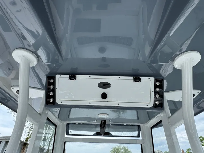 Slide: The Image of 2022 Tidewater 292 CC Adventure boat interior ceiling with storage compartment. - 14