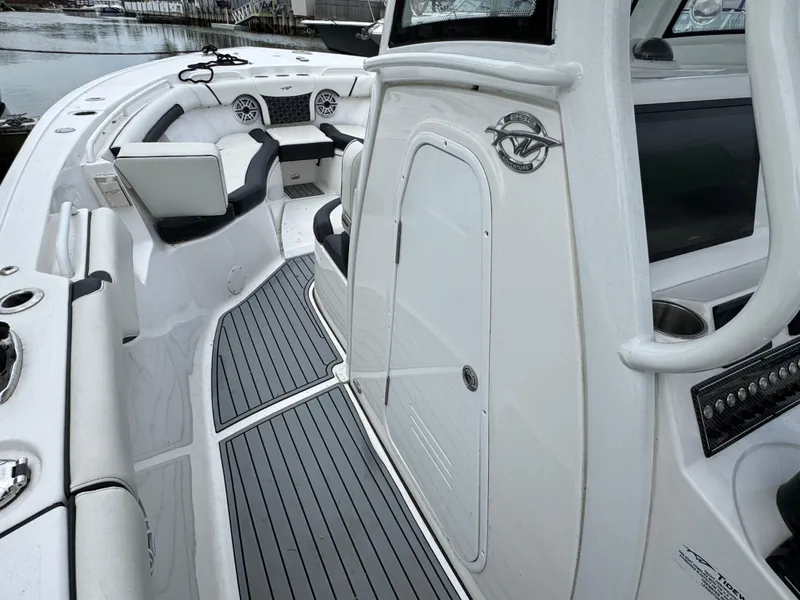 Slide: The Image of 2022 Tidewater 292 CC Adventure boat interior with sleek seating and modern dashboard. - 17