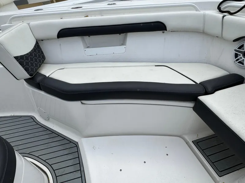 Slide: The Image of 2022 Tidewater 292 CC Adventure boat interior with white and black seating. - 22