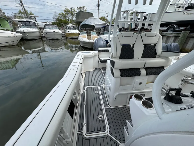 Slide: The Image of 2022 Tidewater 292 CC Adventure boat docked, featuring sleek seating and modern design. - 25