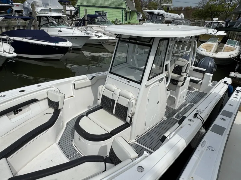 Slide: The Image of 2022 Tidewater 292 CC Adventure boat docked, featuring spacious seating and modern design. - 4