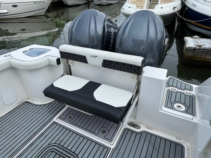 Slide: The Image of 2022 Tidewater 292 CC Adventure boat with dual engines and foldable seating at the dock. - 5