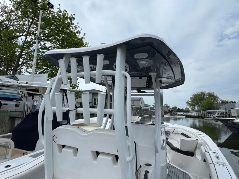Slide: The Image of 2022 Tidewater 292 CC Adventure boat with T-top, docked in a marina. - 8