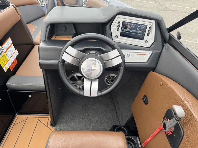 Slide: The Image of 2018 Tigé R21 boat dashboard with steering wheel and digital display. - 10
