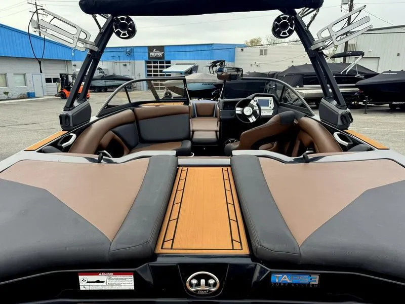 Slide: The Image of 2018 Tigé R21 boat interior with brown seating and modern dashboard. - 3