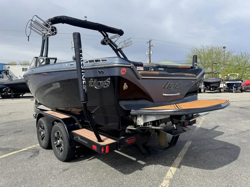 Slide: The Image of 2018 Tigé R21 boat on trailer, parked outdoors, showcasing sleek design and modern features. - 4