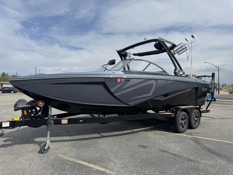 Slide: The Image of 2018 Tigé R21 boat on trailer in parking lot, overcast sky. - 8