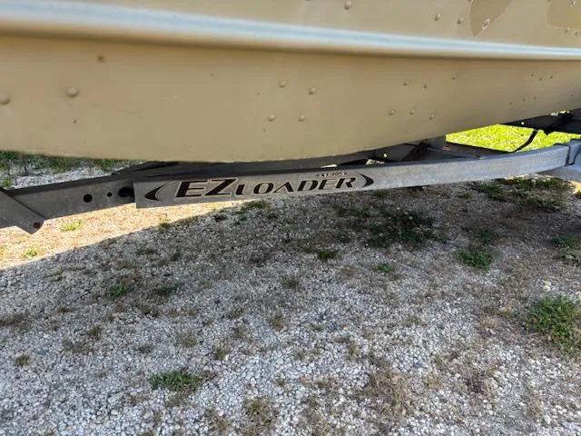 Slide: The Image of 2016 Crestliner CR 1448T boat on EZ Loader trailer, parked on gravel. - 13