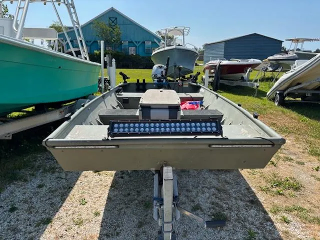 Slide: The Image of 2016 Crestliner CR 1448T boat on trailer, surrounded by other boats, sunny day. - 6