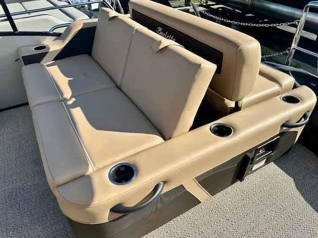 Slide: The Image of 2025 Barletta C24UE boat seating with tan upholstery and cup holders. - 10