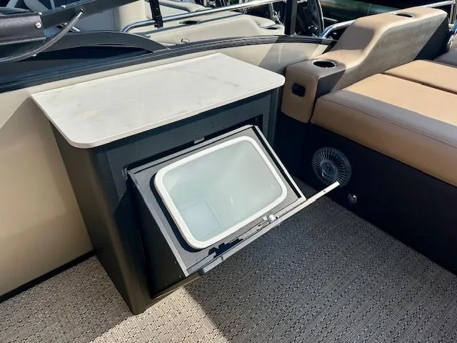 Slide: The Image of 2025 Barletta C24UE boat interior with open cooler compartment. - 16