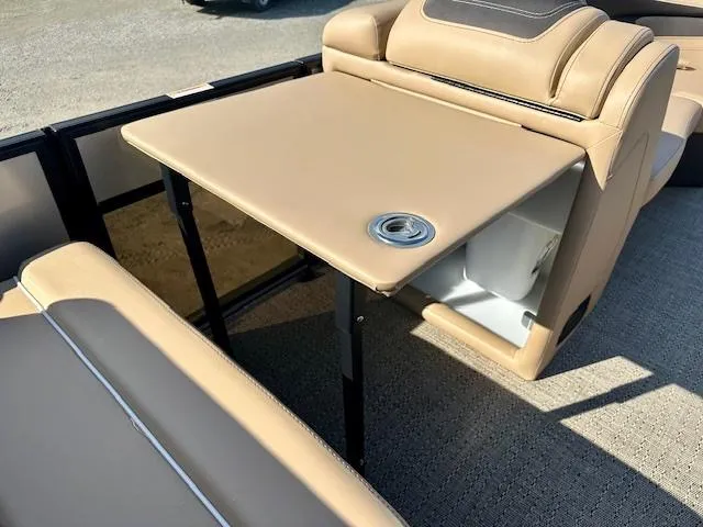 Slide: The Image of 2025 Barletta C24UE boat interior with beige seating and foldable table. - 17