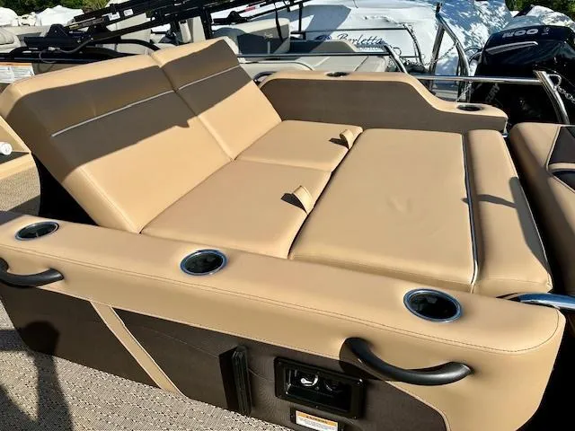Slide: The Image of Luxurious seating on 2025 Barletta C24UE boat with cup holders and tan upholstery. - 18