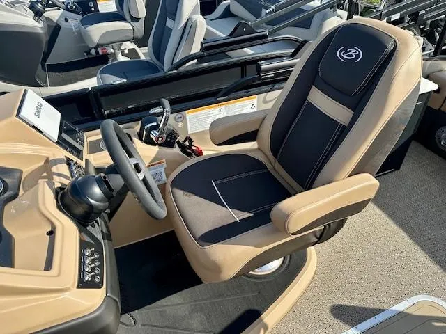 Slide: The Image of Captain's seat of 2025 Barletta C24UE boat, featuring sleek design and modern controls. - 4
