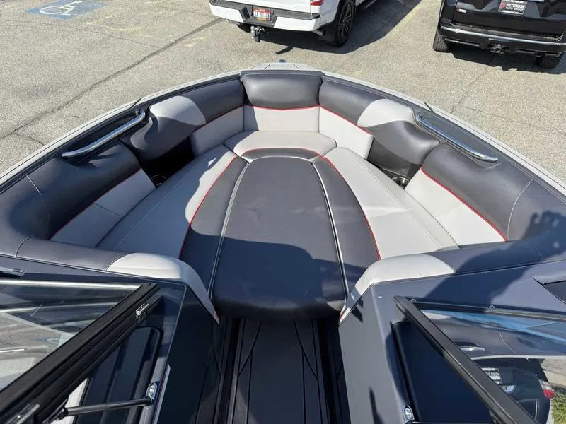 Slide: The Image of 2021 Moomba Craz boat interior with gray and black seating, red accents. - 12
