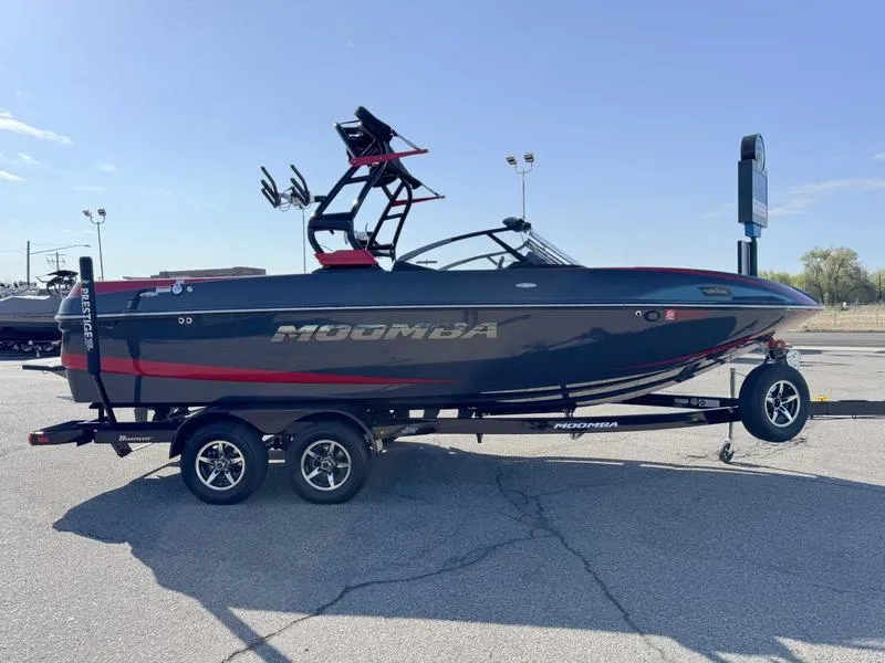 Slide: The Image of 2021 Moomba Craz boat on trailer, black and red design, parked outdoors. - 4