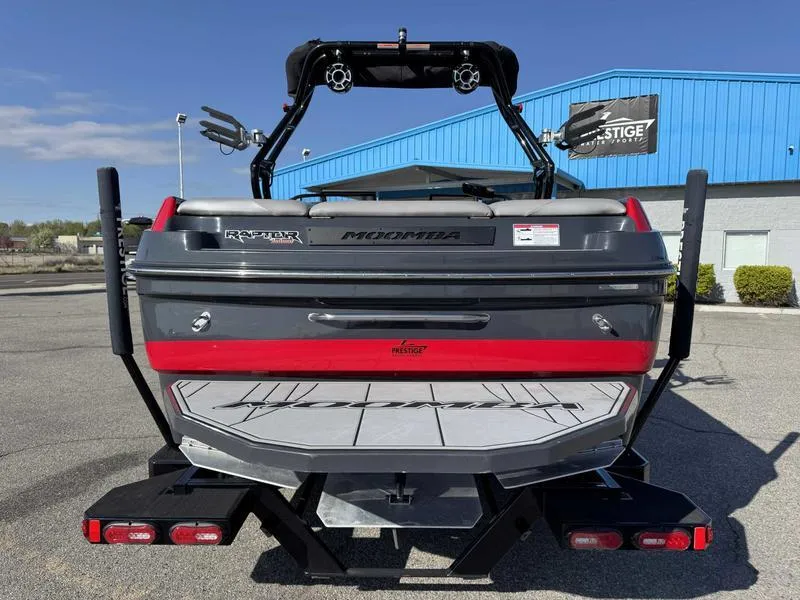 Slide: The Image of 2021 Moomba Craz boat rear view with wakeboard tower, parked outdoors. - 6