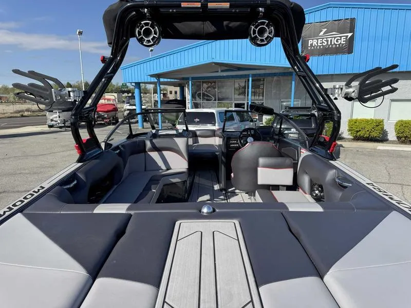 Slide: The Image of 2021 Moomba Craz boat interior with sleek seating and modern design at a dealership. - 7