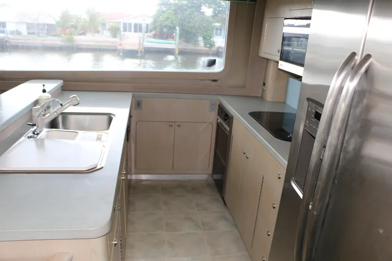 Slide: The Image of Interior of 1990 Donzi 65 yacht kitchen with modern appliances and large window view. - 11