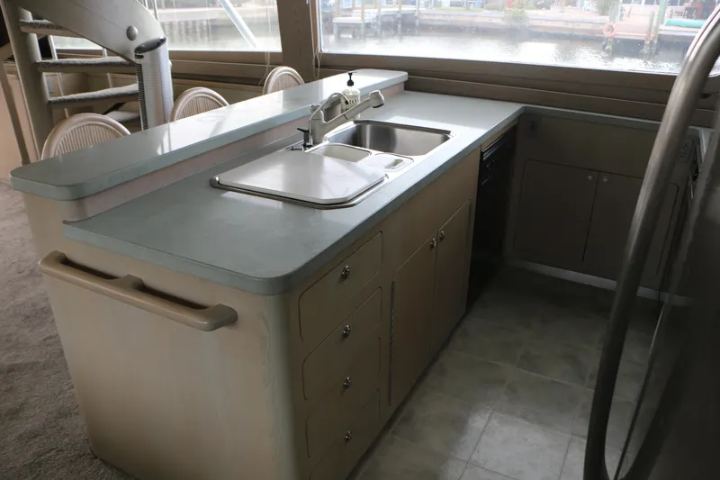 Slide: The Image of Interior kitchen of a 1990 Donzi 65 yacht with modern sink and cabinetry. - 12