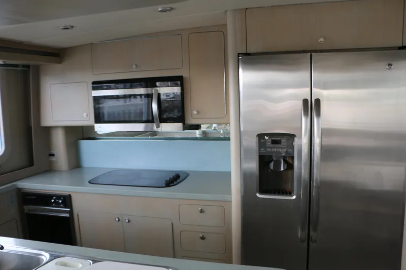 Slide: The Image of Modern kitchen interior of 1990 Donzi 65 yacht with stainless steel appliances. - 13