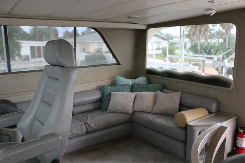 Slide: The Image of Interior of 1990 Donzi 65 yacht with gray seating and large windows. - 15