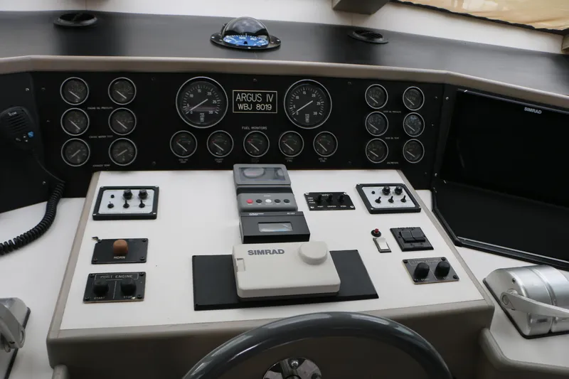 Slide: The Image of Cockpit of a 1990 Donzi 65 boat with navigation instruments and controls. - 17