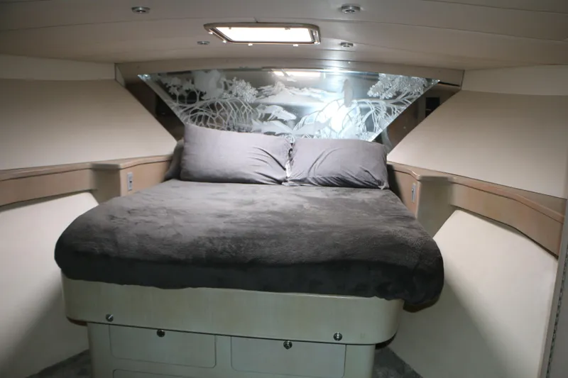 Slide: The Image of Cozy bedroom interior of 1990 Donzi 65 yacht with elegant bedding and decorative wall panel. - 18