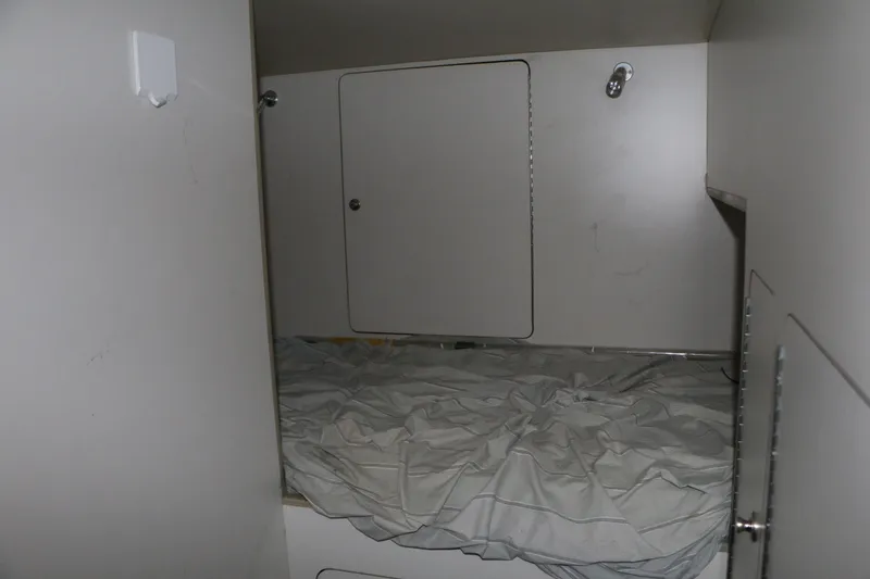 Slide: The Image of Interior cabin of a 1990 Donzi 65 boat with a bed and storage compartment. - 20