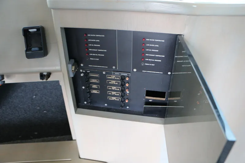 Slide: The Image of Control panel of a 1990 Donzi 65 boat, featuring switches and indicators. - 25