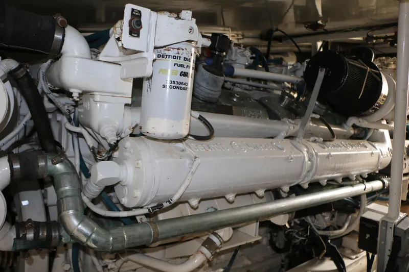 Slide: The Image of Engine room of a 1990 Donzi 65 yacht, featuring a Detroit Diesel engine. - 27