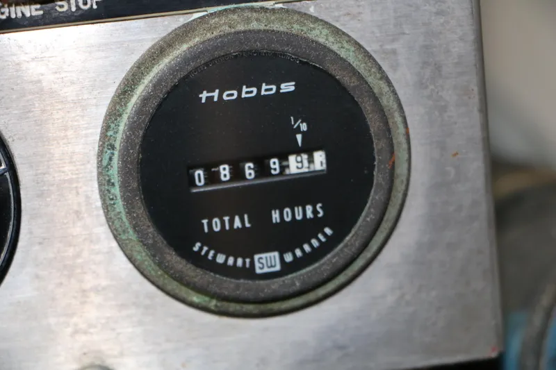 Slide: The Image of Hour meter showing 8699.9 hours on a 1990 Donzi 65 boat. - 28