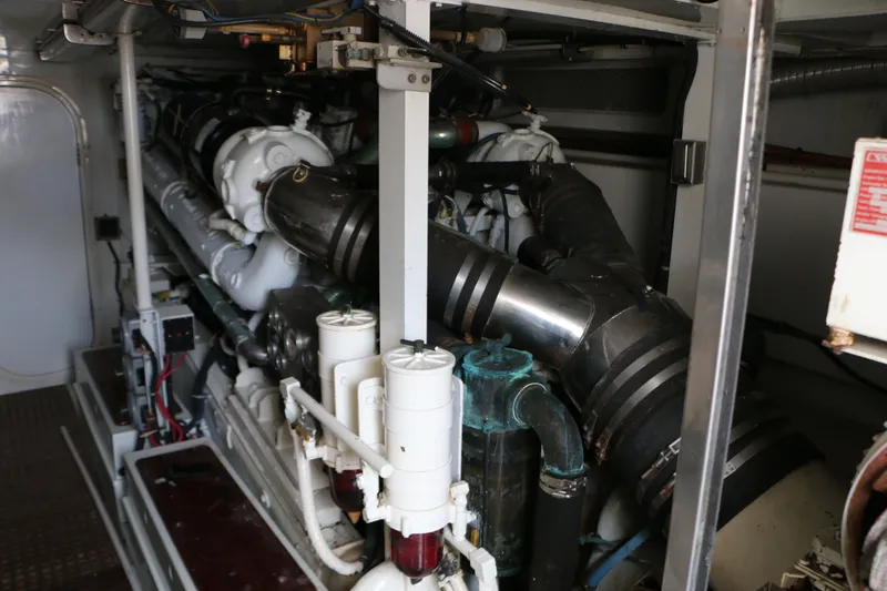 Slide: The Image of Engine room of a 1990 Donzi 65 yacht, showcasing complex machinery and components. - 29