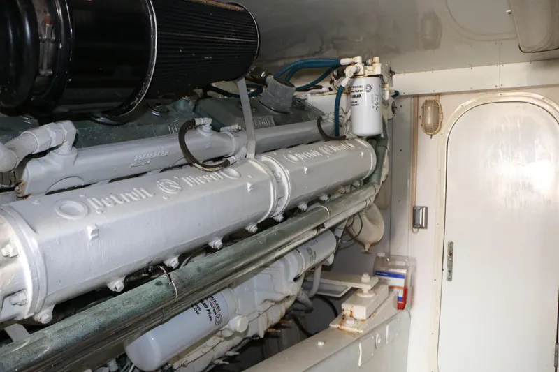 Slide: The Image of Engine room of a 1990 Donzi 65 yacht, showcasing mechanical components and systems. - 30