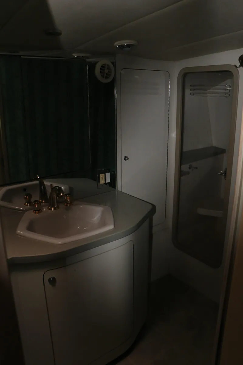 Slide: The Image of 1990 Donzi 65 yacht bathroom with sink and shower area. - 31