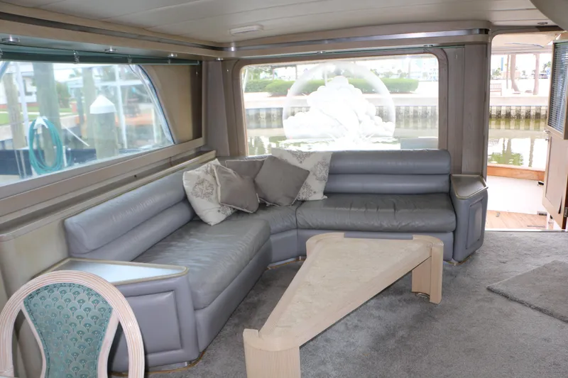 Slide: The Image of Luxurious 1990 Donzi 65 yacht interior with gray leather seating and modern decor. - 6