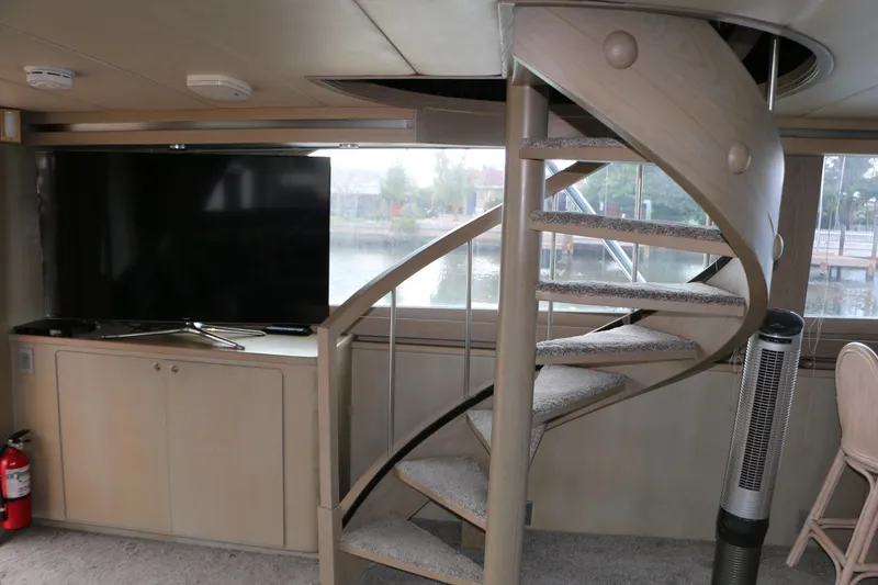 Slide: The Image of Interior of 1990 Donzi 65 yacht with spiral staircase and TV setup. - 8