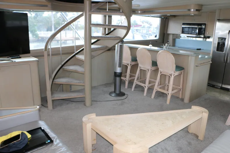 Slide: The Image of Interior of a 1990 Donzi 65 yacht with spiral staircase and modern kitchen. - 9