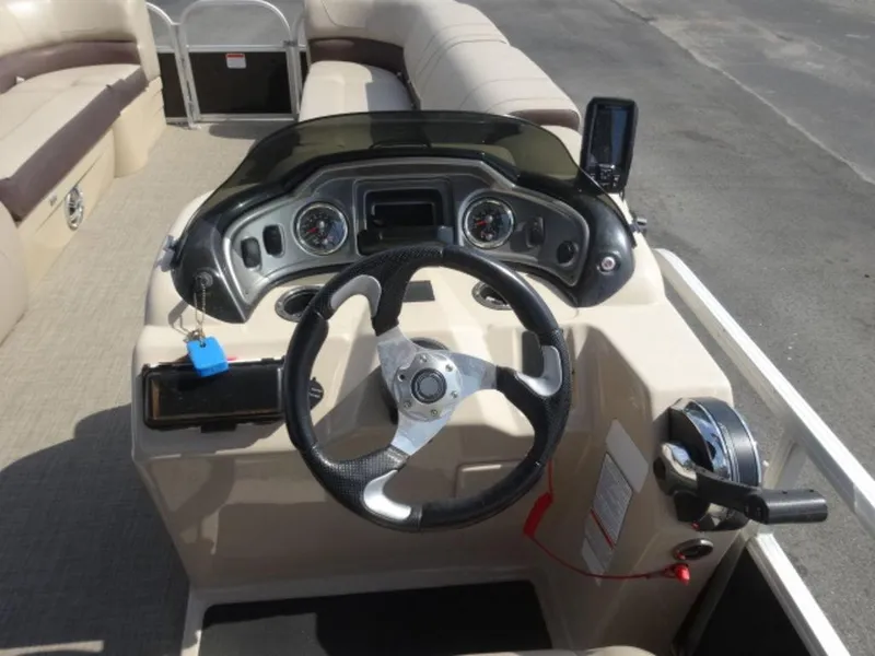 Slide: The Image of 2018 Sun Tracker 24XP3 boat dashboard with steering wheel and control panel. - 11