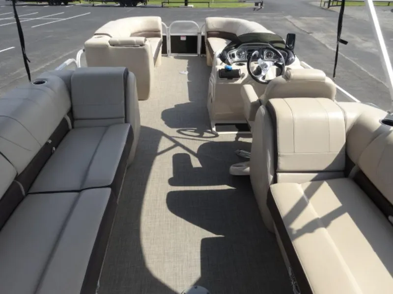 Slide: The Image of 2018 Sun Tracker 24XP3 pontoon boat interior with beige seating and steering console. - 16