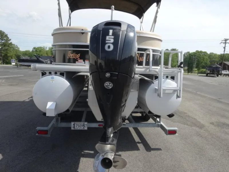 Slide: The Image of 2018 Sun Tracker 24XP3 pontoon boat with 150 HP outboard motor, parked on trailer. - 6