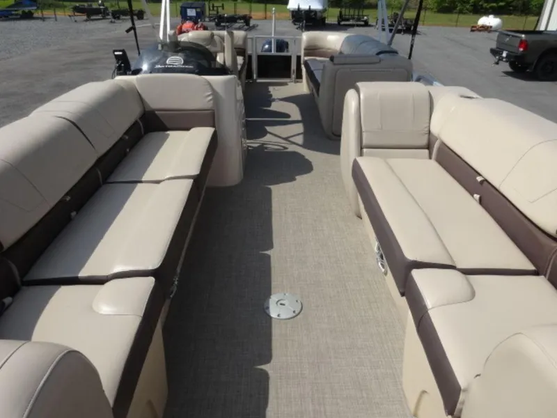 Slide: The Image of 2018 Sun Tracker 24XP3 pontoon boat interior with beige seating and spacious layout. - 7
