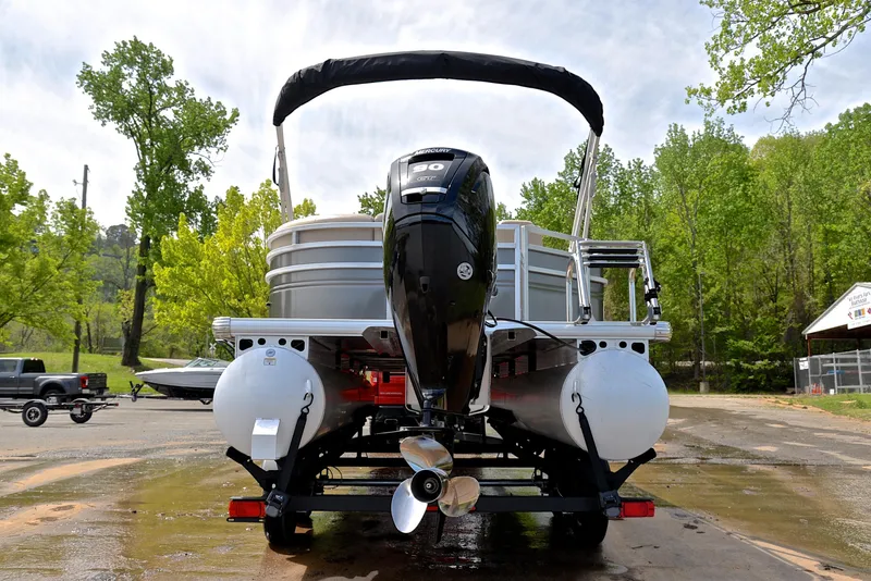 Slide: The Image of 2024 Sun Tracker Party Barge 20 DLX pontoon boat on trailer, rear view. - 13