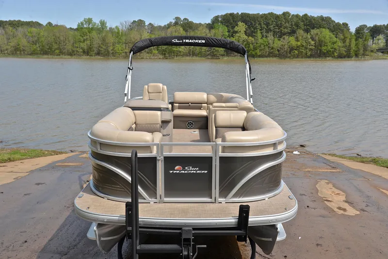 Slide: The Image of 2024 Sun Tracker Party Barge 20 DLX pontoon boat on a lakefront. - 17