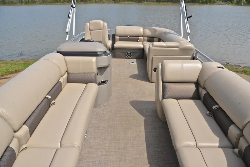 Slide: The Image of 2024 Sun Tracker Party Barge 20 DLX interior with spacious seating on a calm lake. - 20